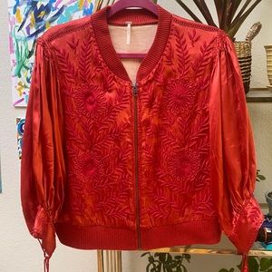 Red silk embroidered free people bomber jacket with tassels